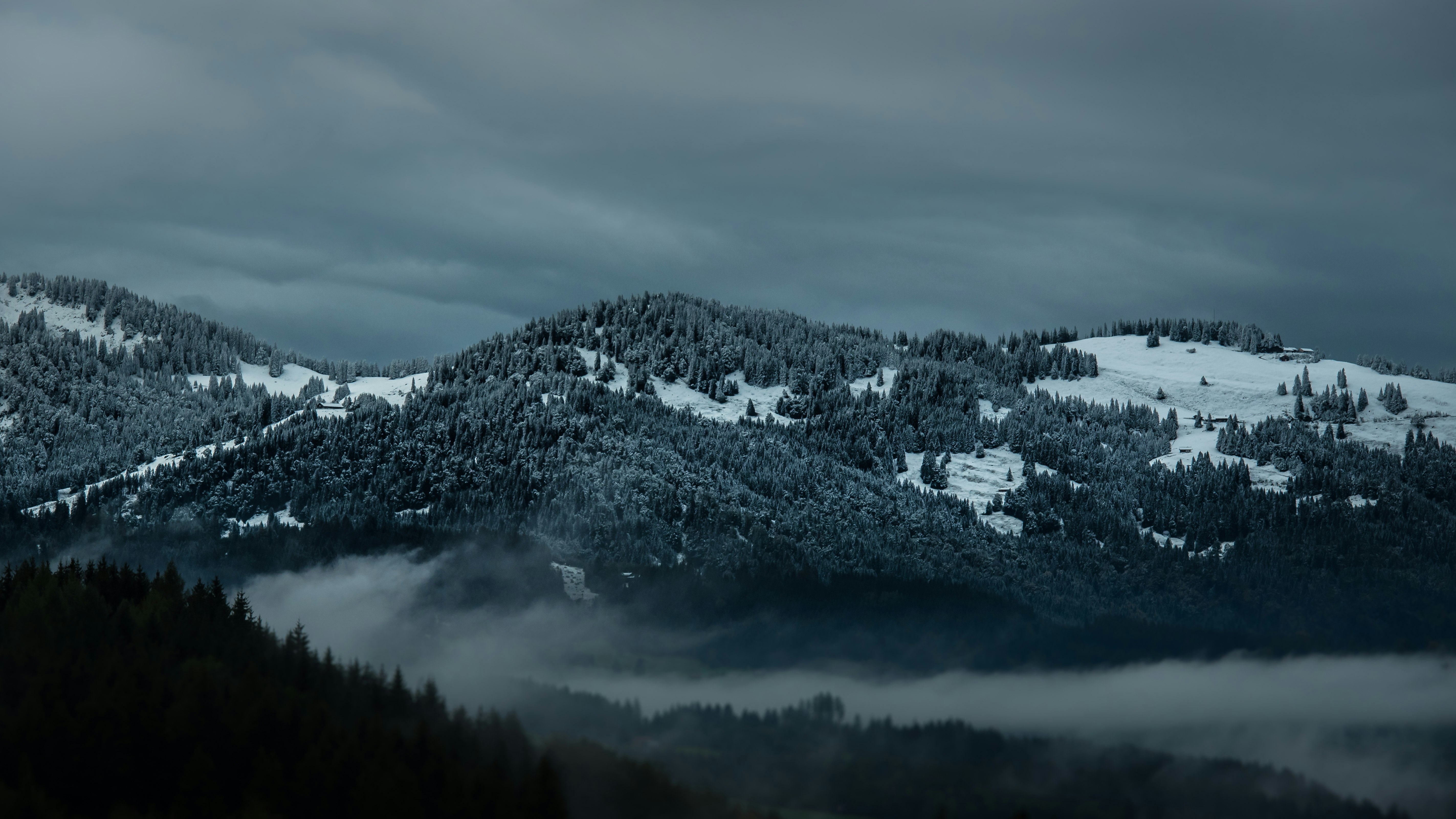 snow covered mountain under cloudy sky during daytime